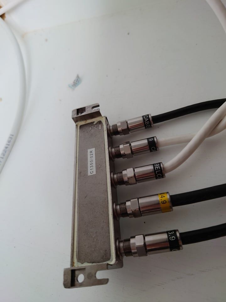 5 splitter from top to bottom: black cable goes outside house to kitchen tv box, white cable to living room tv box (same room), white cable to 2/1 splitter, black cable goes outside to virgin modem (which is connected to ubiquiti for routing/networking), black cable goes outside to bedroom tv box